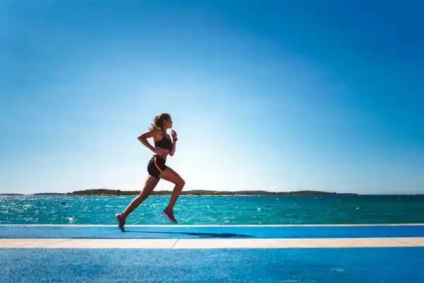 Woman running showing strong leg muscle Port Glasgow